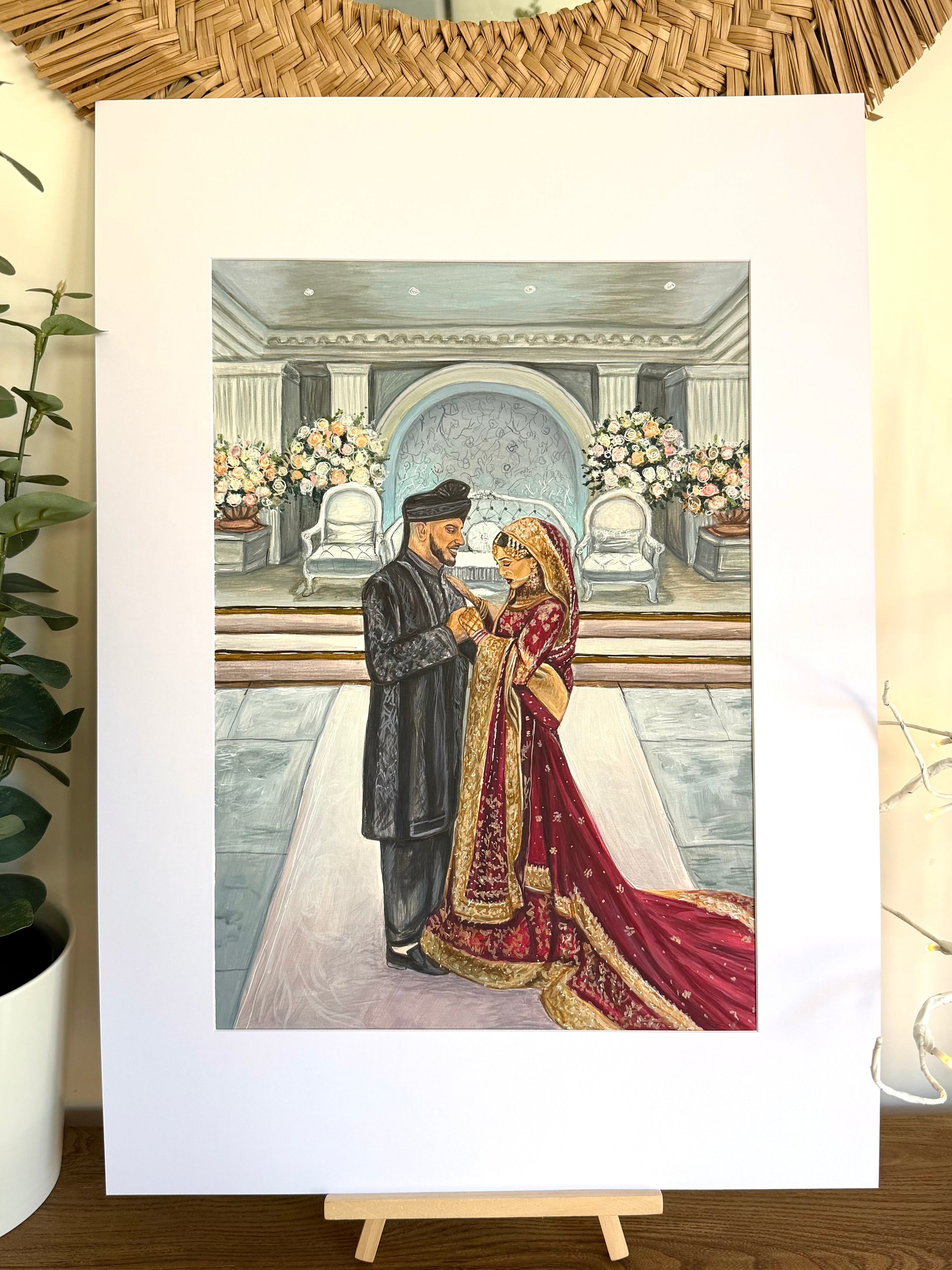Indian wedding portrait of a couple in traditional dress displayed on an easel